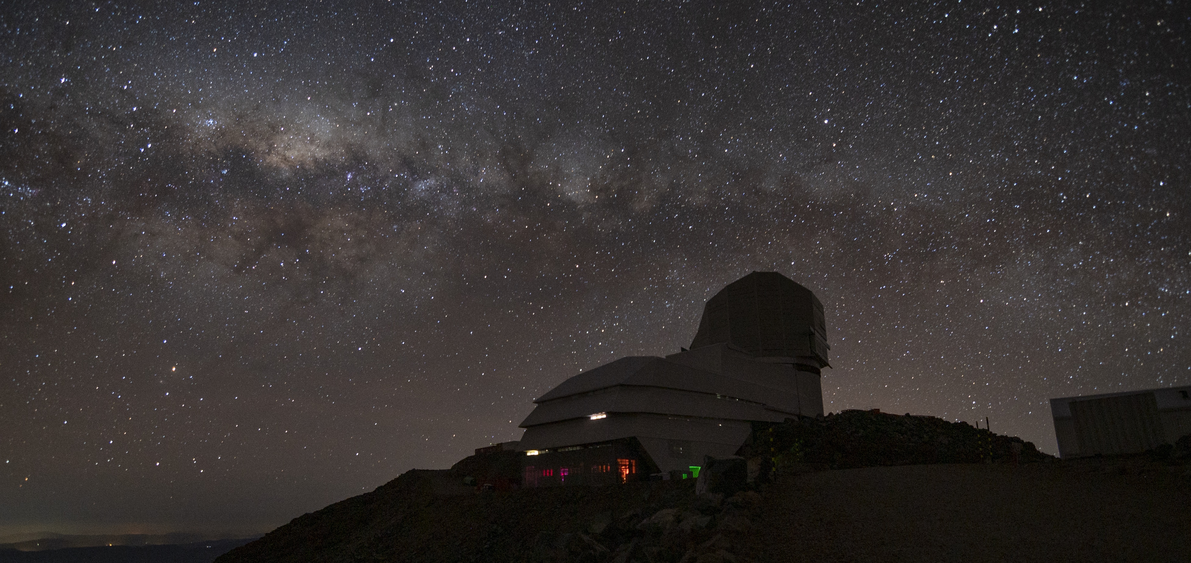 Rubin Observatory from a bird's eye view with the dome open with the telescope visible